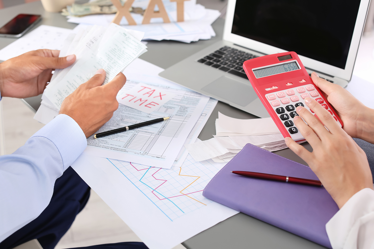 calculating-taxes-with-receipts-laptop-and-calculator