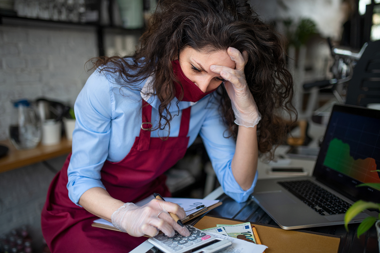 frustrated-coffee-shop-manager-calculating-figures