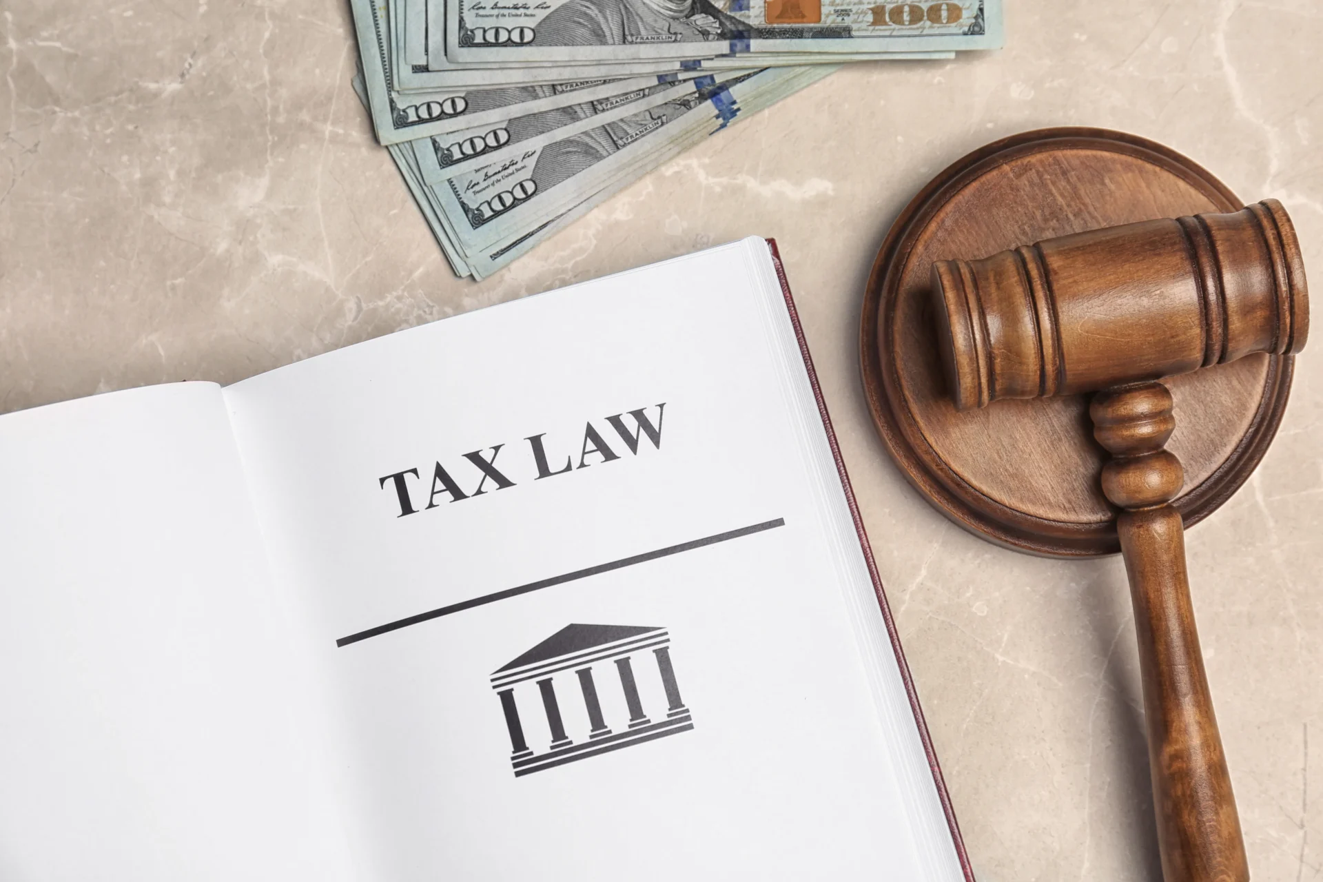 money-gavel-and-book-with-words-tax-law-on-grey-b-2026-03-05-11-39-30-utc