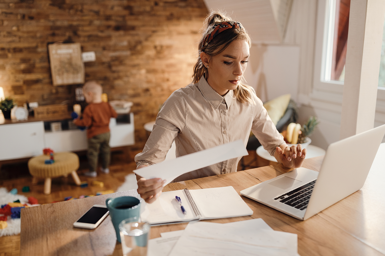 woman-working-at-home-with-child-nearby
